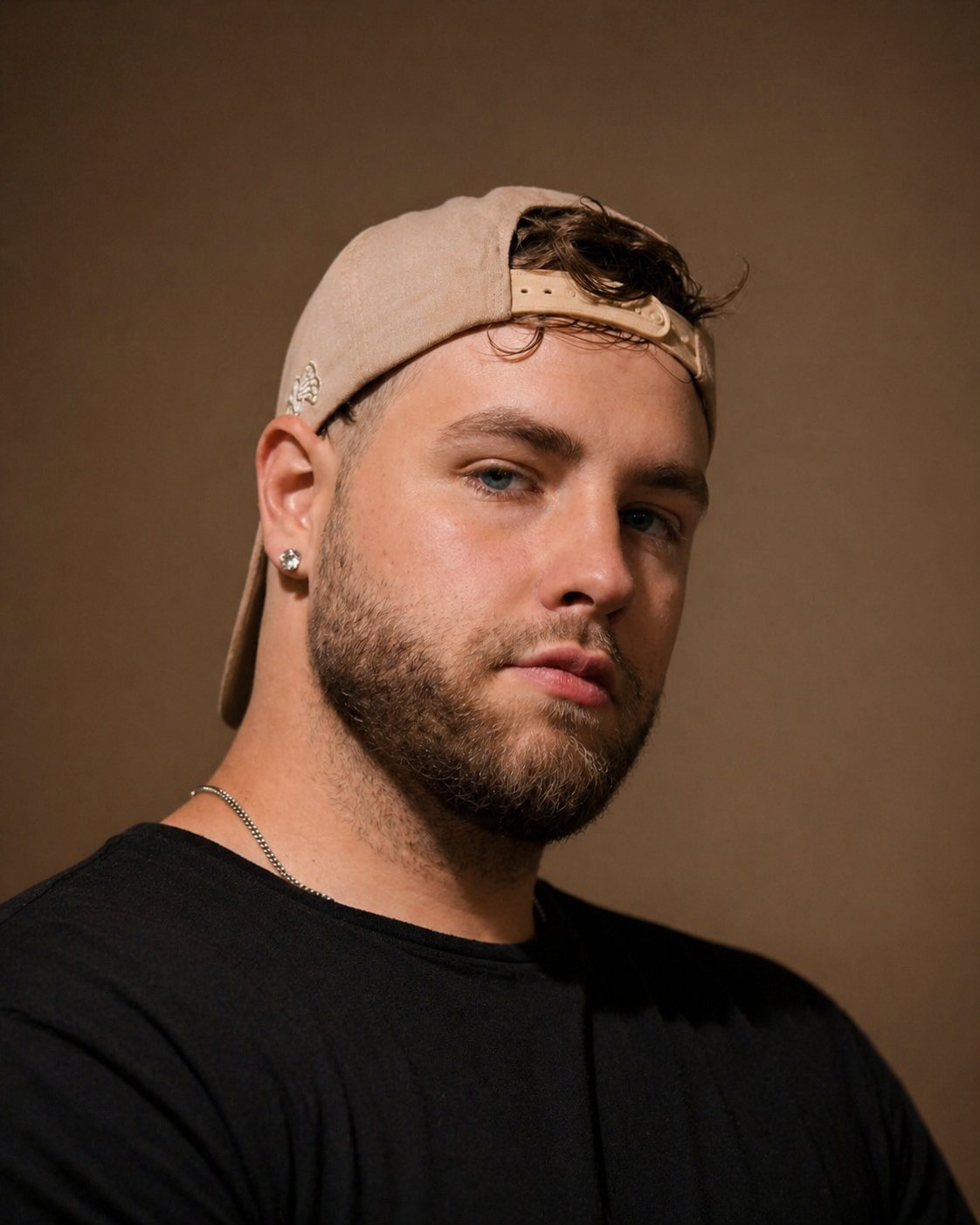 Grant Keller in a backwards cap against a brown backdrop